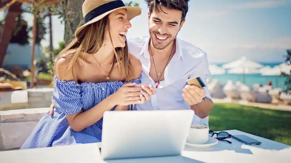 Couple Using a Laptop While on a Vacation - OneAir